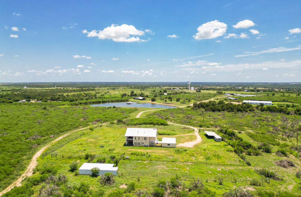 aerial view of house and pond